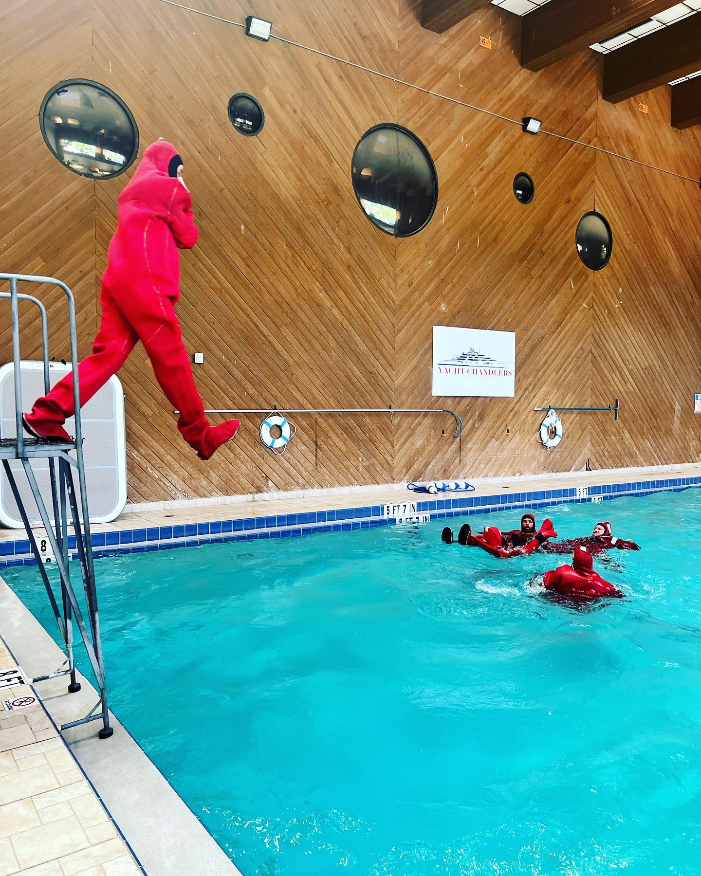 Students practicing personal survival techniques in the indoor pool