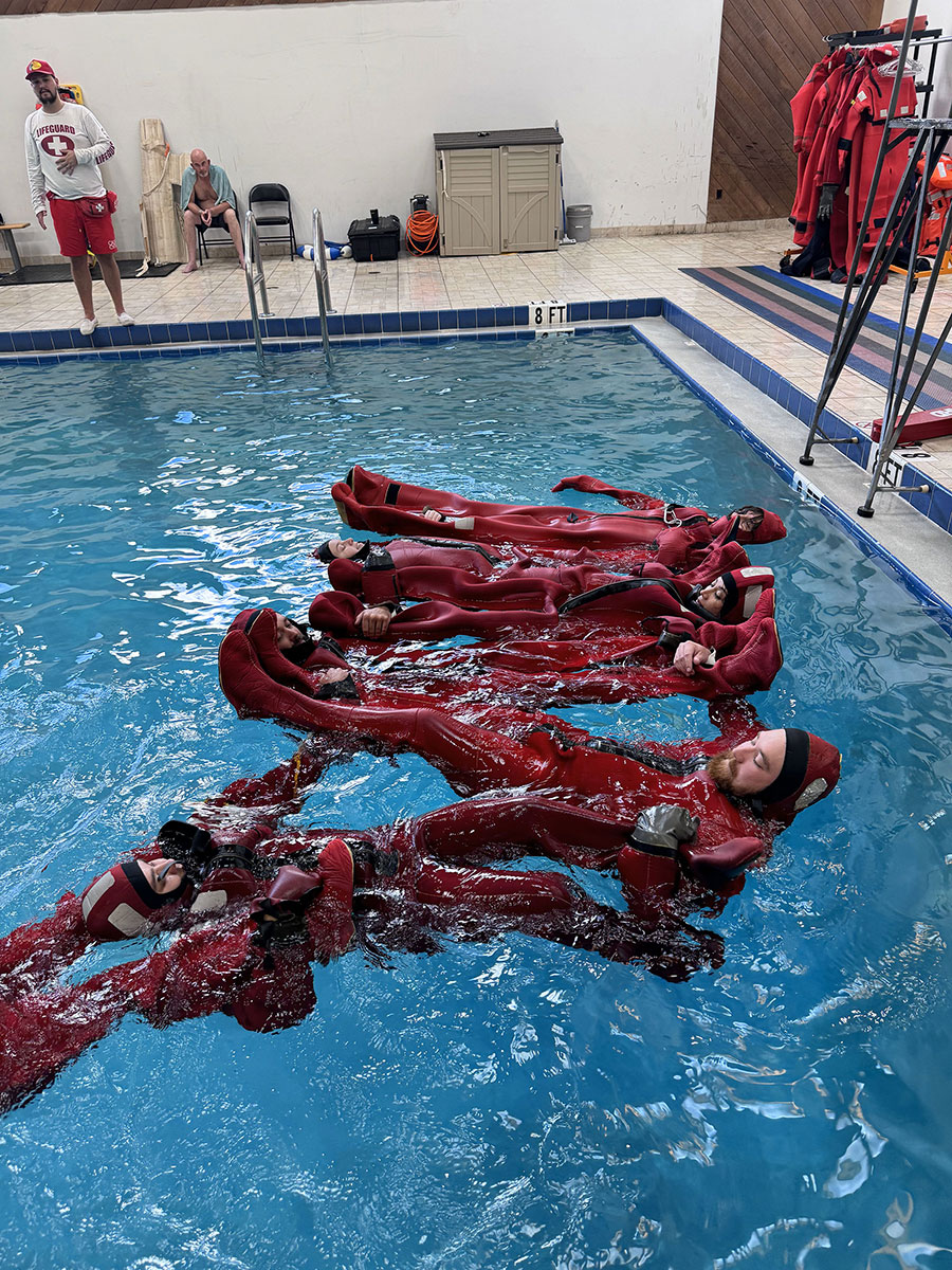 Students practicing personal survival techniques in the indoor pool